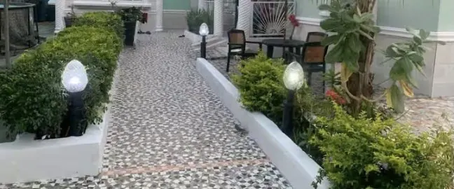 Garden walkway with hedges and path lights